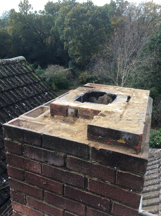 Professionally rebuilt chimney stack with new brickwork and fresh concrete crown after chimney restoration in Hertfordshire.