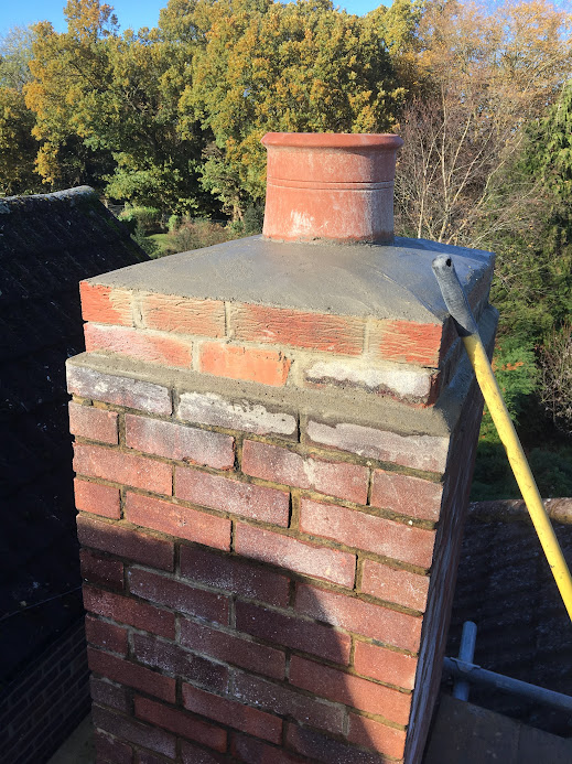 Professionally refurbished chimney stack with new concrete crown, repointed brickwork and restored chimney pot in Hertfordshire.