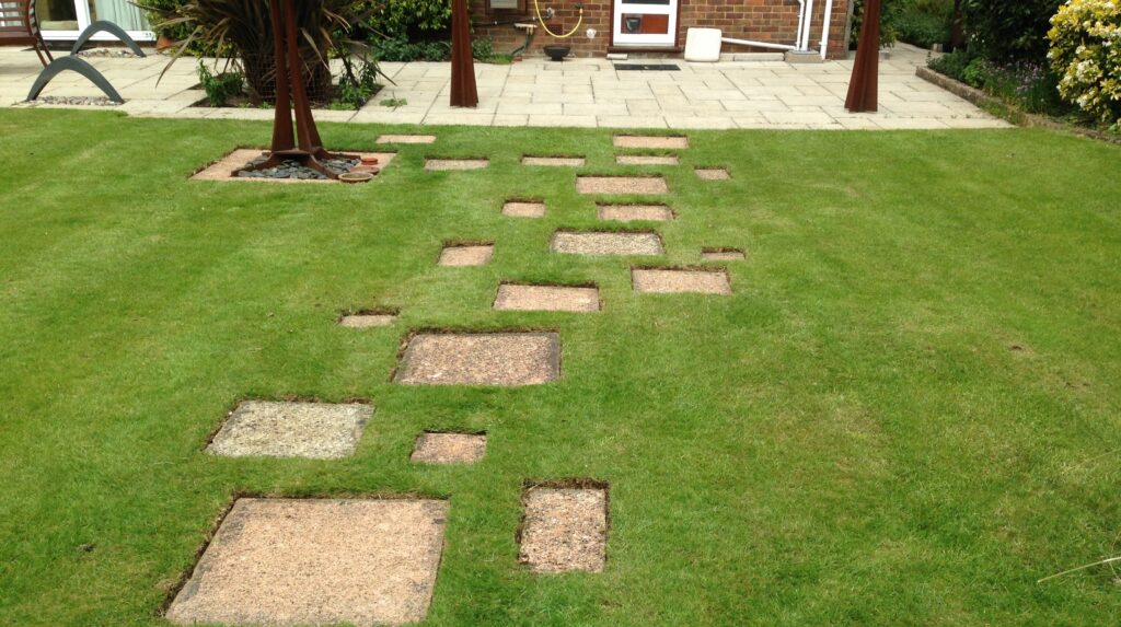 Garden with decorative stepping stones set into a freshly maintained lawn