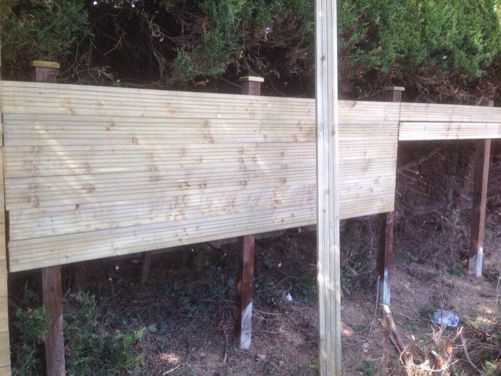 New timber fence installation with concrete repair spurs and pressure-treated posts completed by RidgeOak in Hertfordshire.